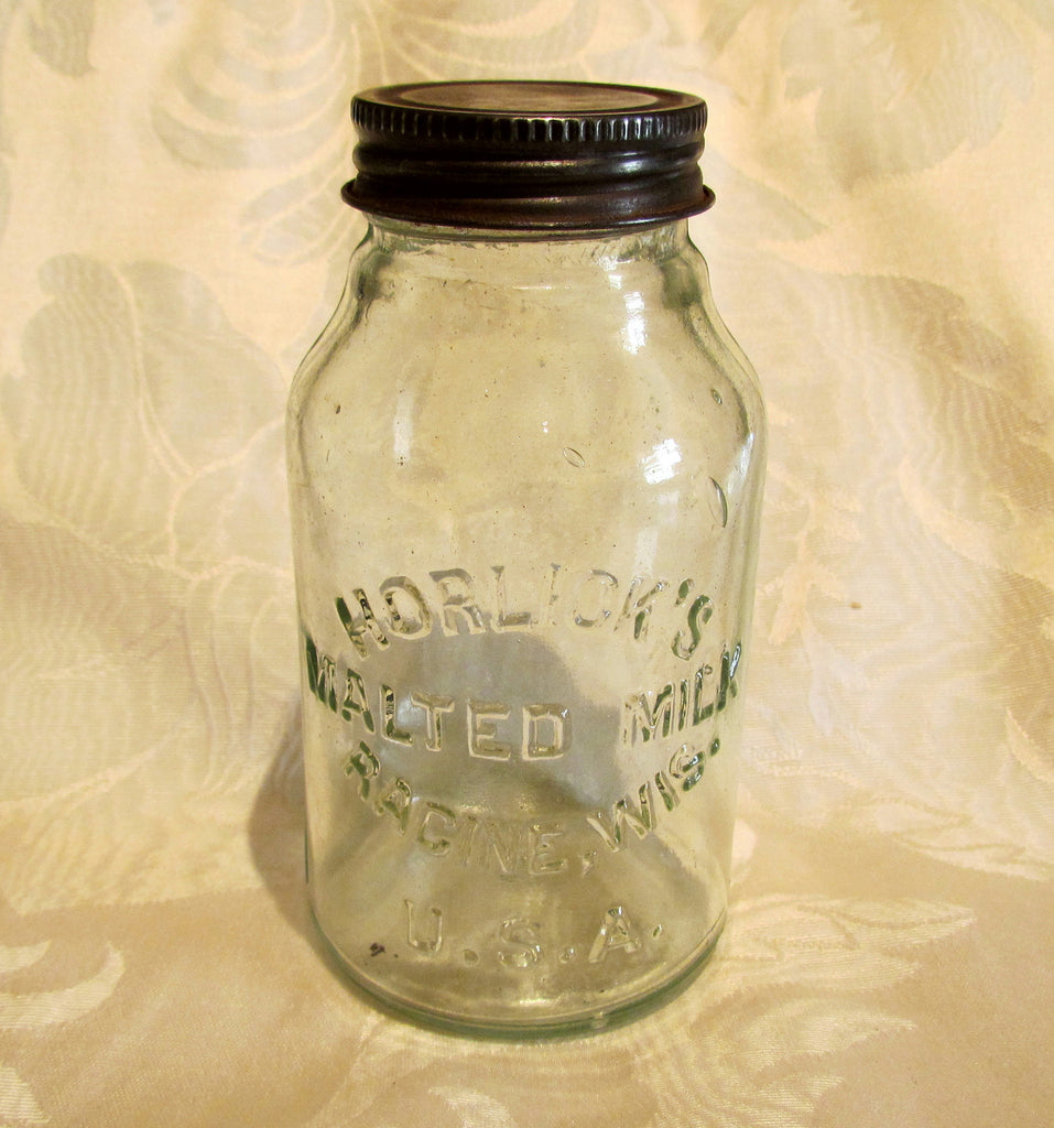 Havahart trap, knife, and vintage Horlick's malted milk bottle